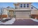 Exterior shot of home showing well maintained landscape, two car garage and brick driveway at 18372 E 100Th Pl, Commerce City, CO 80022