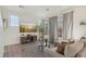 Living room with L-shaped sofa, large windows, and a large TV at 18372 E 100Th Pl, Commerce City, CO 80022