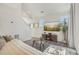 Living room with L-shaped sofa, large windows, and a large TV at 18372 E 100Th Pl, Commerce City, CO 80022