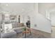 Living room with gray sofa, hardwood floors, and a view of the kitchen at 18372 E 100Th Pl, Commerce City, CO 80022