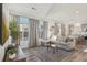 Bright living room featuring expansive windows, hardwood floors, and stylish decor at 18372 E 100Th Pl, Commerce City, CO 80022