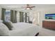 Main bedroom with a ceiling fan and an ensuite bathroom at 18372 E 100Th Pl, Commerce City, CO 80022