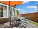 Outdoor patio featuring a table and chairs and a cozy umbrella at 18372 E 100Th Pl, Commerce City, CO 80022