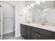 Modern bathroom with double vanity, a large mirror, and a shower at 461 Interlocken Blvd # 102, Broomfield, CO 80021