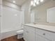 Clean bathroom with white vanity, bathtub, and a large mirror at 461 Interlocken Blvd # 102, Broomfield, CO 80021