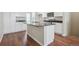 Kitchen island with dark countertop and white cabinets at 461 Interlocken Blvd # 102, Broomfield, CO 80021