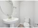 Small powder room with pedestal sink and toilet at 461 Interlocken Blvd # 102, Broomfield, CO 80021