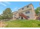 Backyard featuring a wooden deck, a grassy lawn, and mature trees at 3223 Castle Peak Ave, Superior, CO 80027