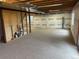Unfinished basement with exposed beams and walls covered in plastic at 3223 Castle Peak Ave, Superior, CO 80027