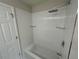 Shower with white subway tile walls, rainfall shower head and glass shelves at 3223 Castle Peak Ave, Superior, CO 80027