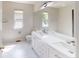Bright bathroom featuring double sinks, white marble floors and large mirror at 3223 Castle Peak Ave, Superior, CO 80027