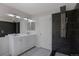 Bathroom featuring double sinks, modern shower and dark tile accent wall at 3223 Castle Peak Ave, Superior, CO 80027