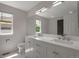Bright bathroom featuring double sinks, white marble floors and large mirror at 3223 Castle Peak Ave, Superior, CO 80027