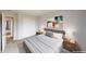 Neutral bedroom with a large bed, dresser, and a view to the doorway at 3223 Castle Peak Ave, Superior, CO 80027