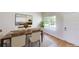 Bright dining room featuring a wood table, seating for four, and a view from the entry at 3223 Castle Peak Ave, Superior, CO 80027