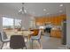 Bright kitchen features wood cabinetry, modern appliances, and breakfast nook with outdoor views at 3223 Castle Peak Ave, Superior, CO 80027