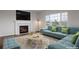 Bright living room features a fireplace, hardwood floors and a large window with a view at 3223 Castle Peak Ave, Superior, CO 80027