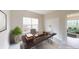 Office with a large desk, window view, and view to the living room at 3223 Castle Peak Ave, Superior, CO 80027