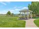 Community picnic area with covered tables and benches, perfect for outdoor gatherings and enjoying the surrounding green space at 3223 Castle Peak Ave, Superior, CO 80027