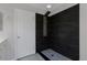 Modern shower with dark tile accent wall, rainfall shower head and glass shelves at 3223 Castle Peak Ave, Superior, CO 80027