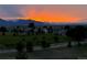 Stunning sunset over rolling green hills, houses, and mountains, promising breathtaking views and a serene neighborhood at 3223 Castle Peak Ave, Superior, CO 80027