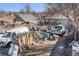 An expansive backyard filled with an assortment of materials, vehicles, and equipment at 47 Osceola St, Denver, CO 80219