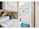 Bright bathroom with a shower-tub combo, white tile, and a window at 47 Osceola St, Denver, CO 80219