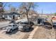 Blue single story home with a large tree in the front yard and multiple parked cars at 47 Osceola St, Denver, CO 80219