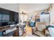 Open-concept living area with TV, ceiling fan, desk, and comfortable seating at 47 Osceola St, Denver, CO 80219