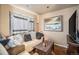 Comfortable living room with a plush sofa, cozy decor, and natural light at 47 Osceola St, Denver, CO 80219