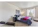 Cozy bedroom with a comfortable bed, natural light, and a view of the outdoors at 875 E 78Th Ave # 7, Denver, CO 80229