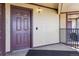 Close-up of a unit entry door with classic hardware, set within a charming apartment complex at 875 E 78Th Ave # 7, Denver, CO 80229