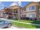 A beautiful three-story apartment building featuring a stone facade, balconies, and inviting stairs at 875 E 78Th Ave # 7, Denver, CO 80229
