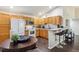 Functional kitchen with a breakfast bar, wood cabinets, and modern appliances at 875 E 78Th Ave # 7, Denver, CO 80229