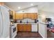 Updated kitchen featuring wood cabinets and breakfast bar at 875 E 78Th Ave # 7, Denver, CO 80229
