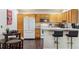 Functional kitchen featuring wood cabinets and dining area at 875 E 78Th Ave # 7, Denver, CO 80229