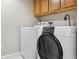 Laundry area featuring a large washing machine, dryer, and cabinets above for storage at 875 E 78Th Ave # 7, Denver, CO 80229