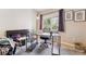 Bright office with a black desk, comfortable chair, and natural light from the window at 875 E 78Th Ave # 7, Denver, CO 80229
