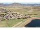 Aerial view of a charming community near a lake, with winding roads and scenic mountain views at 4346 S Quail St, Littleton, CO 80127