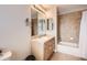 Well-maintained bathroom with a vanity, mirrored cabinet, bathtub, and shower combination at 4346 S Quail St, Littleton, CO 80127