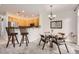 Cozy dining area with a glass table, chairs, and kitchen bar seating at 4346 S Quail St, Littleton, CO 80127