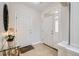 Bright foyer with tile flooring, a decorative table, and white doors at 4346 S Quail St, Littleton, CO 80127