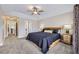 Large main bedroom with tray ceiling, ceiling fan, two windows, and neutral-toned walls and carpet at 4346 S Quail St, Littleton, CO 80127