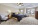 Spacious main bedroom with tray ceiling, ceiling fan, two windows, and neutral-toned walls and carpet at 4346 S Quail St, Littleton, CO 80127