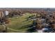 Aerial view of park with lush greenery, walking paths, and surrounding buildings in a tranquil setting at 1310 N Corona St # A, Denver, CO 80218