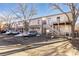 A beautiful apartment complex showcasing multiple units with stairs and a parking area at the front at 1310 N Corona St # A, Denver, CO 80218