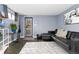 Modern living room with stylish gray walls, a black leather couch, and decor at 1310 N Corona St # A, Denver, CO 80218