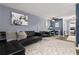 Comfortable living room with modern decor and black leather couch, ideal for relaxation and entertainment at 1310 N Corona St # A, Denver, CO 80218
