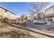 Outdoor view of apartments with a parking lot and mature trees offering shade to the property at 1310 N Corona St # A, Denver, CO 80218