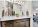 Bright bathroom boasts double vanity, framed mirrors, pendant lights, and a shower in the background at 240 S Oak Hill St, Aurora, CO 80018